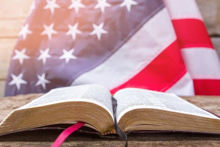 Open Bible with American flag in the background
