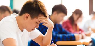 Stressed college student for exam in classroom