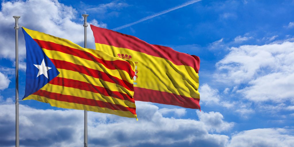 Catalonia and Spain flags waving on blue sky background. 3d illustration